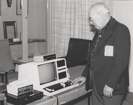 Man touches the keyboard of a computer with a voice output attached
