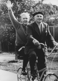 Two men riding a tandem bicycle