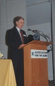 Robin Pleydell addresses the crowd from a podium on stage