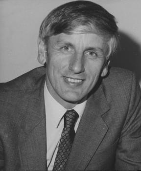 Close up of man's face as he smiles towards camera