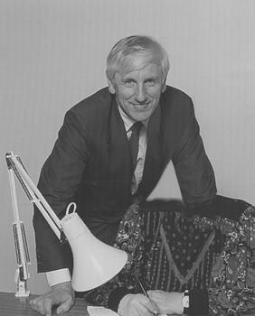 Badly photoshopped picture of John Cook with fake arm and missing head of woman writing on notepad