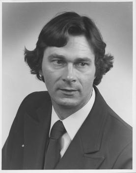 Man in suit and tie looks off camera