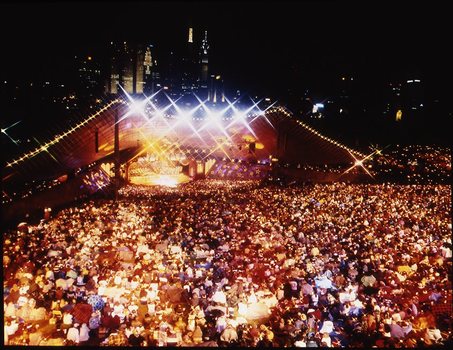 Melbourne city skyline at night with Myer Music Bowl and crowds
