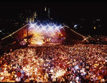 Melbourne city skyline at night with Myer Music Bowl and crowds