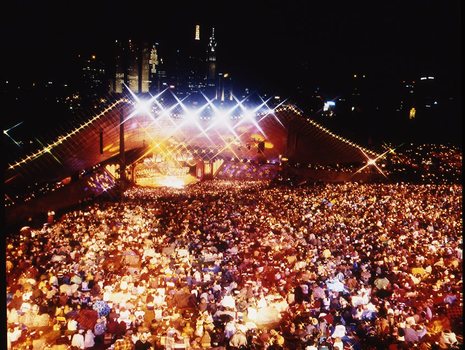 Melbourne city skyline at night with Myer Music Bowl and crowds