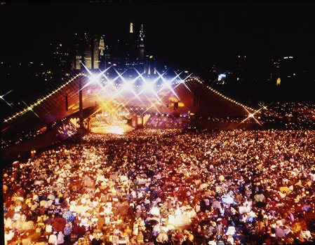 Melbourne city skyline at night with Myer Music Bowl and crowds