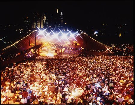 Melbourne city skyline at night with Myer Music Bowl and crowds