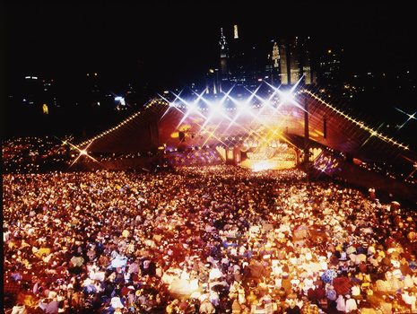 Melbourne city skyline at night with Myer Music Bowl and crowds