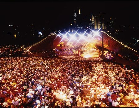 Melbourne city skyline at night with Myer Music Bowl and crowds