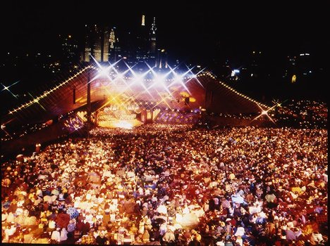 Melbourne city skyline at night with Myer Music Bowl and crowds