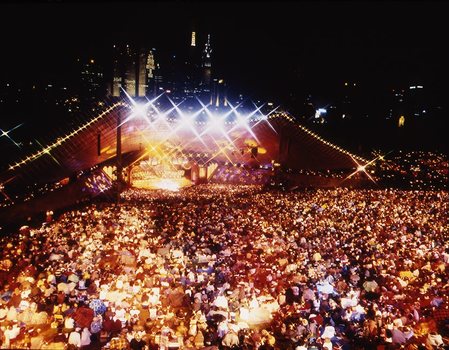 Melbourne city skyline at night with Myer Music Bowl and crowds