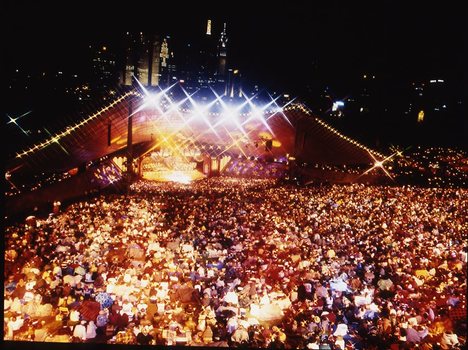 Melbourne city skyline at night with Myer Music Bowl and crowds