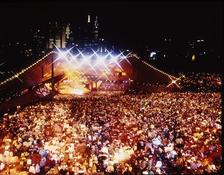 Melbourne city skyline at night with Myer Music Bowl and crowds