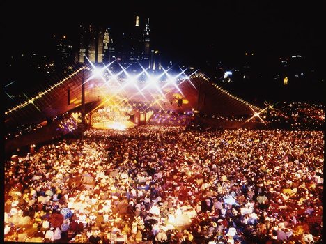 Melbourne city skyline at night with Myer Music Bowl and crowds