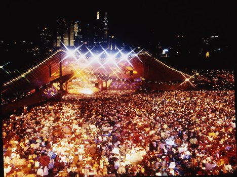 Melbourne city skyline at night with Myer Music Bowl and crowds