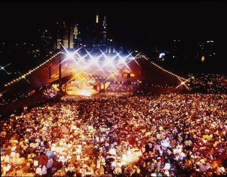 Melbourne city skyline at night with Myer Music Bowl and crowds