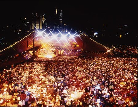 Melbourne city skyline at night with Myer Music Bowl and crowds