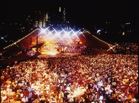 Melbourne city skyline at night with Myer Music Bowl and crowds