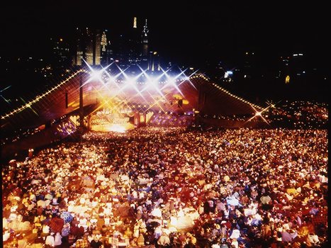 Melbourne city skyline at night with Myer Music Bowl and crowds