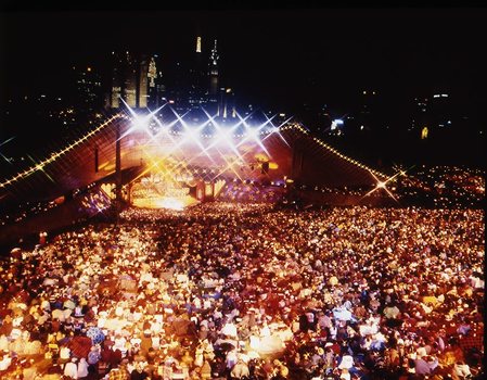 Melbourne city skyline at night with Myer Music Bowl and crowds