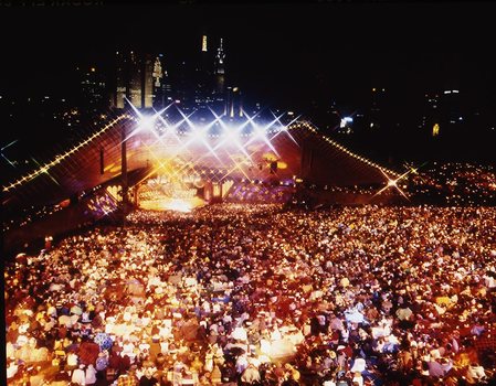 Melbourne city skyline at night with Myer Music Bowl and crowds