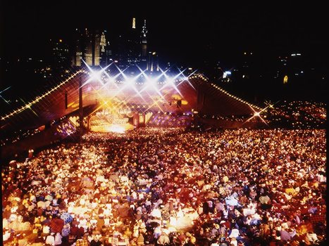 Melbourne city skyline at night with Myer Music Bowl and crowds