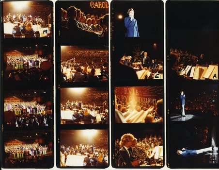Various performers singing on stage at Carols