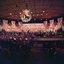 1977 stage setting with colourful giant cherubs with horns flying along the back and middle top