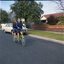 Two school girls riding a tandem bike