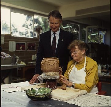 Robin Pleydell stands next to female client holding a clay bowl