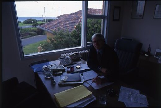 Side view of John Cook in his office and what he can see out the window