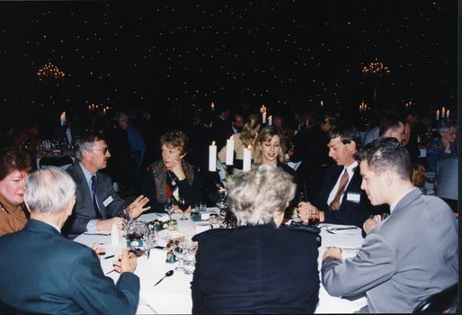 Group of guests chat at the table