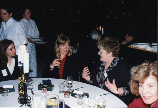 Women chat around the table, second from right is Margaret Bull, Director of Children's Services