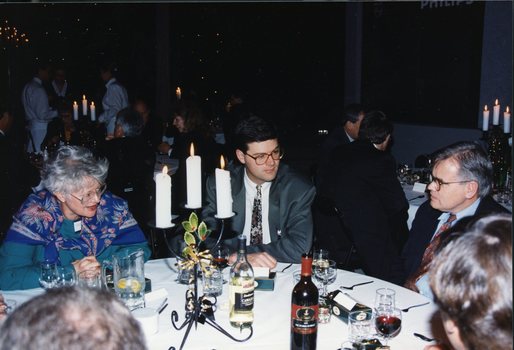 Three people speaking whilst they wait for their next course
