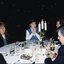 Two woman speaking with others at their table during the luncheon