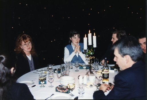 Two woman speaking with others at their table during the luncheon