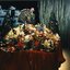Table of hampers, preserves, wine and Christmas puddings