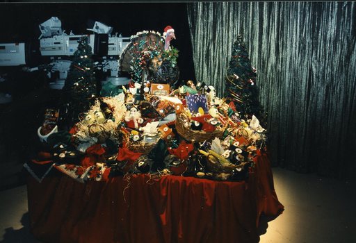 Table of hampers, preserves, wine and Christmas puddings