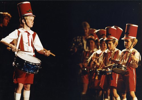 Boy drummers in costume on stage
