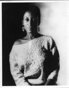 Woman wearing jumper falling off one shoulder and dangling earrings