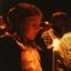 Child looking at her candle in the audience