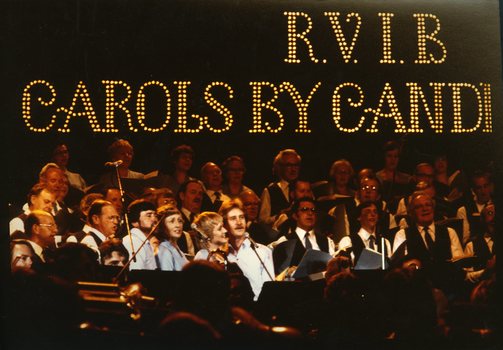 Choir and musicians on stage at Carols