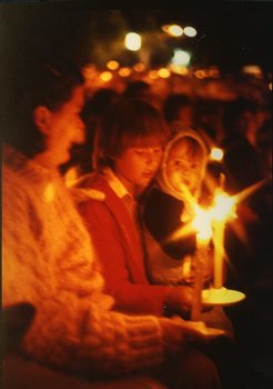 Family holding candles in the audience