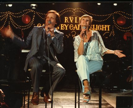 Paul Meenie and Linda George singing on stage