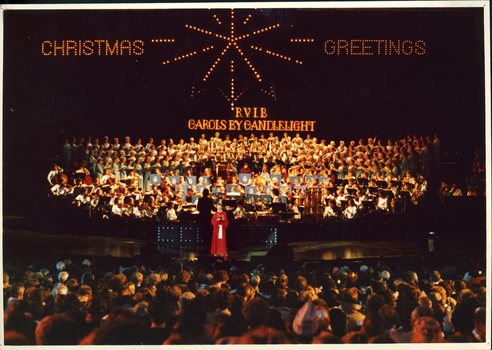 Richard Casey in front of the choir and orchestra on stage