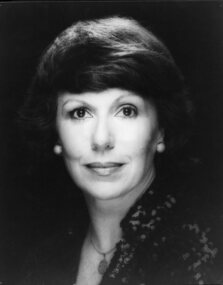 Woman looking to camera wearing high colour sequinned jacket in black and white photo