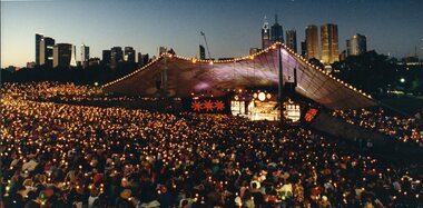View of Melbourne skyline, crowds and stage at dusk