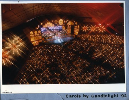 Birds eye view of stage and crowd who are watching a performer dressed in pink