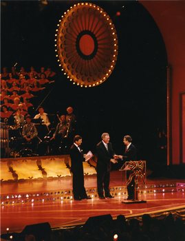 Doug Kent shakes hands with major sponsor as Ray Martin looks on