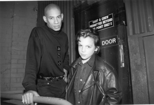 A man and boy stand outside the stage door at the Sidney Myer Music Bowl